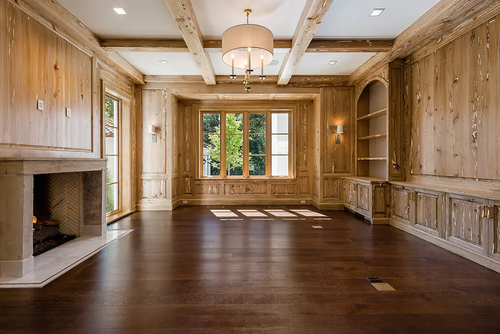 A wood-lined living room contrasts with the lighter interiors. (Photo by Stephen Reed)