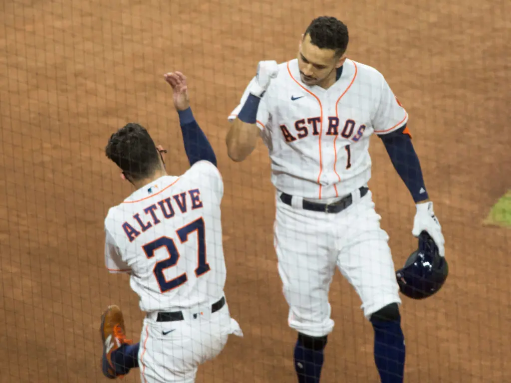 Carlos Correa and Jose Altuve celebrate a little differently in these coronavirus times. (Photo by F. Carter Smith)