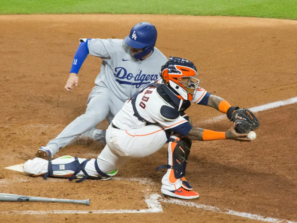 Los Angeles Dodgers outfielder  AJ Pollock scores when catcher Martin Maldonado cannot handle an errant throw home from Alex Bregman. (Photo by F. Carter Smith)