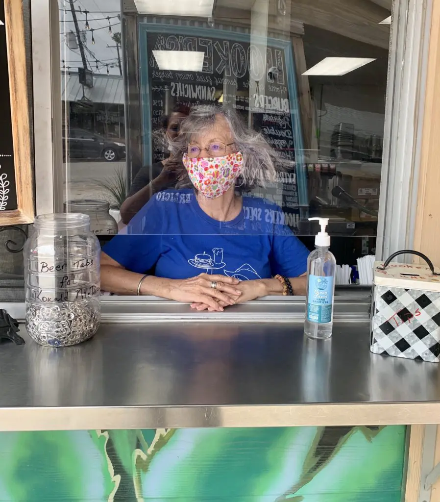 Ruth Hooker's mom, Kathryn Hooker, now takes orders behind plexiglass.