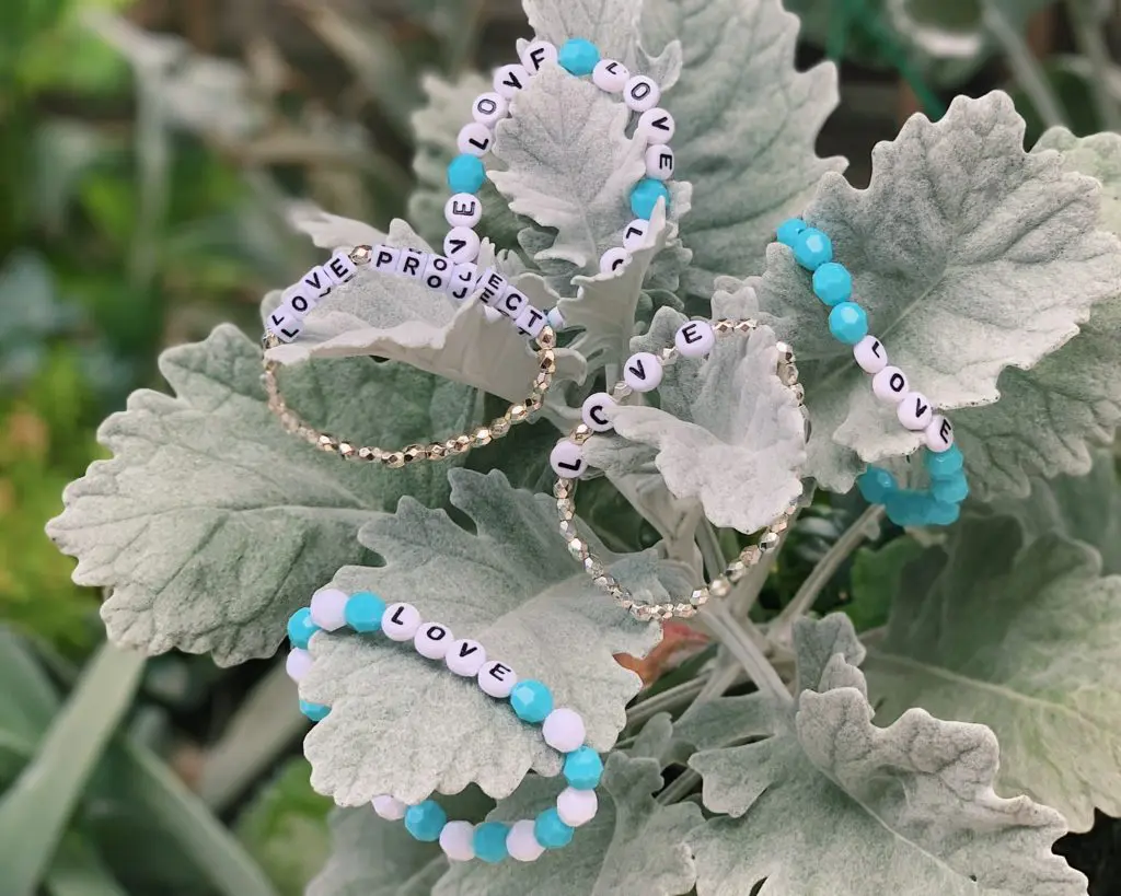 Gia McCrae makes L.O.V.E. Project bracelets for essential workers, friends, and family.