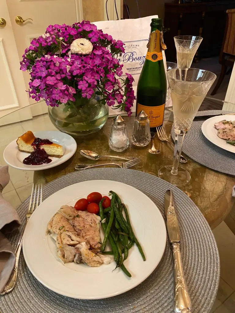 The kitchen table set for three with take-out dinner from a'Bouzy. 