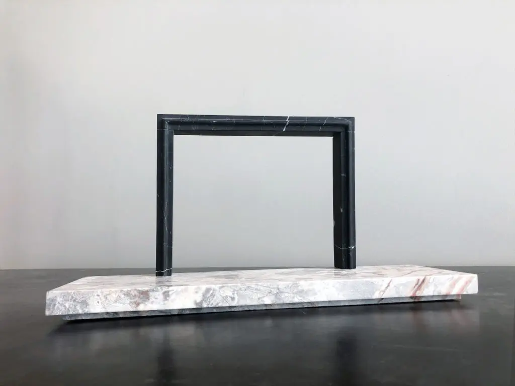 Big Sur surround in nero with a Breccia Nuvole marble hearth in a honed finish