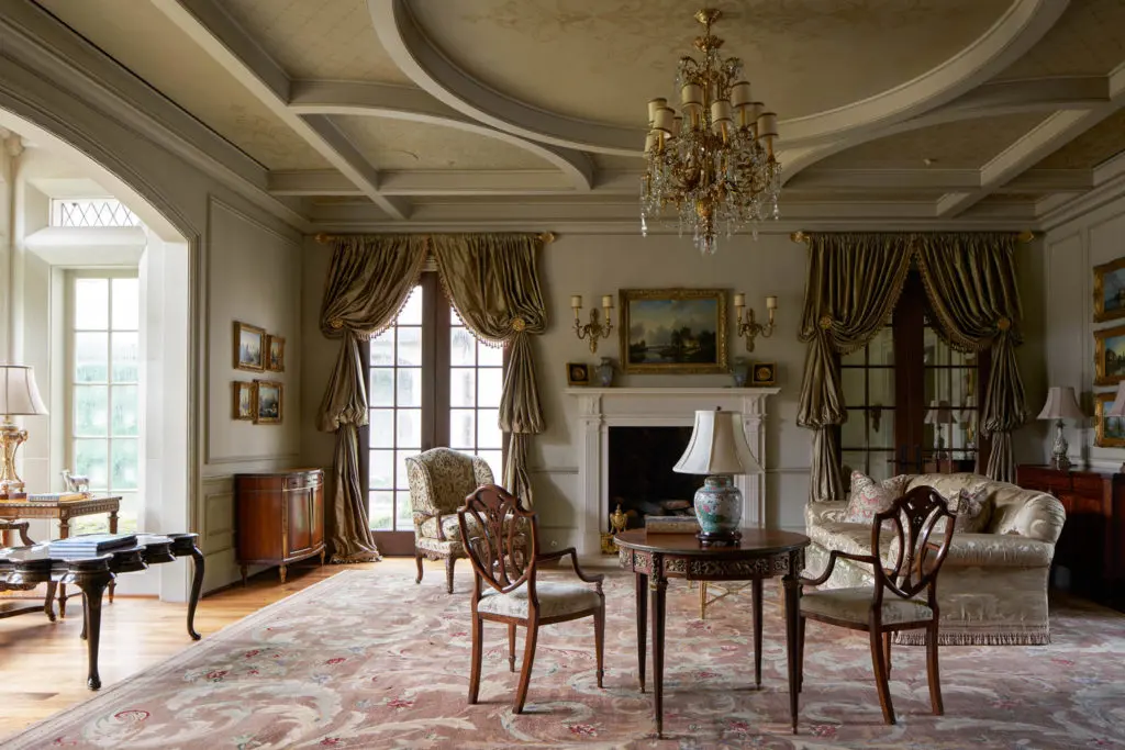 The receiving room at 120 
Carnarvon has an ornate coffered ceiling accented with gold-leaf, French bois-style paneling, and mirrored interior French doors. (Photo by Nathan Schroder/Douglas Elliman)