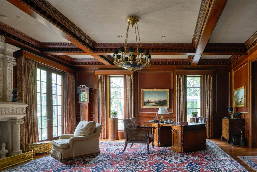 One of two studies at 120 Carnarvon with imported, carved limestone fireplace. (Photo by Nathan Schroder/Douglas Elliman)