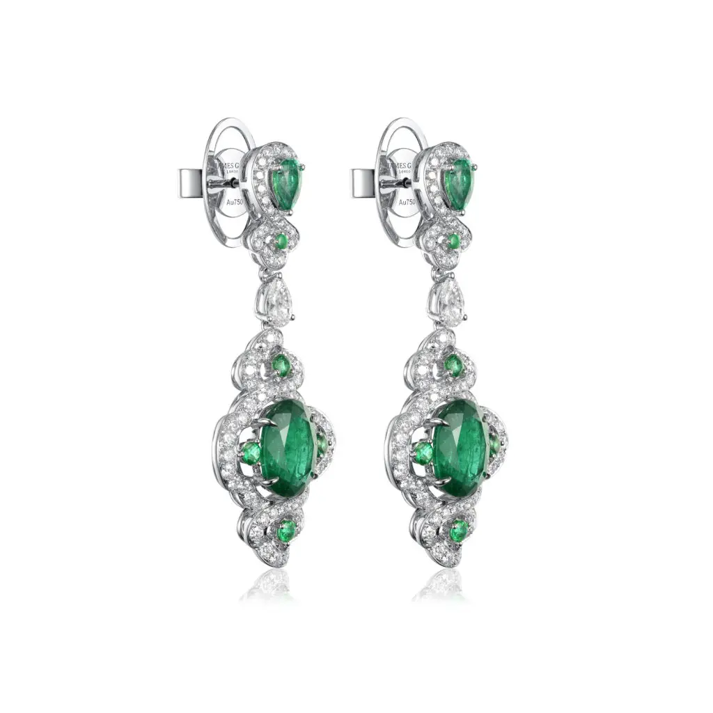 A close-up of Fabergé x James Ganh white gold, emerald and diamond earrings.