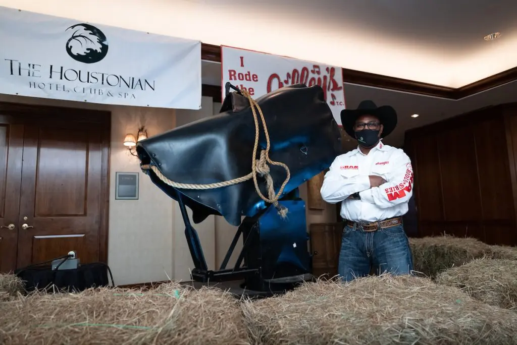 Tommie Mitchell with Gilley's mechanical bull on display at The Houstonian Hotel, Club & Spa (Photo by Daniel Ortiz)