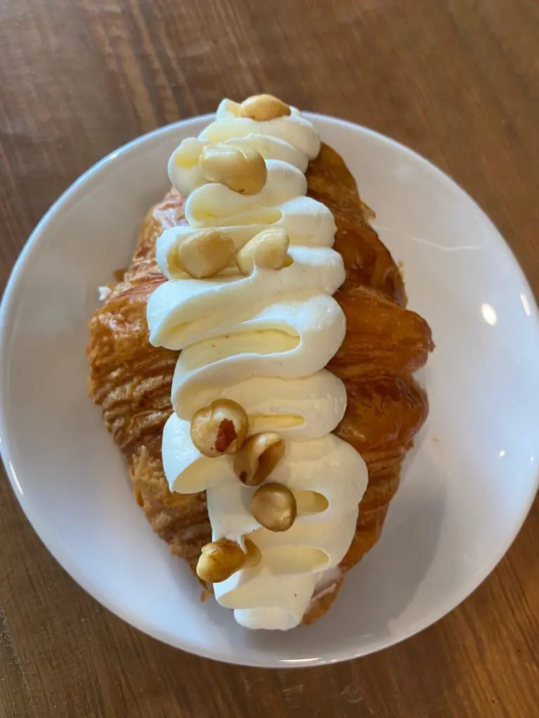 The amazing PJ&B croissant at While Elm Café composed of Peanut Butter, Strawberry Jam, Cream Cheese
Chantilly, and Roasted Salted Peanuts. (Photo by Shelby Hodge)