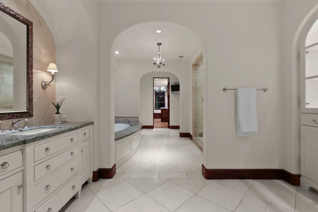 Space is separated with his and hers vanities and dressing.
