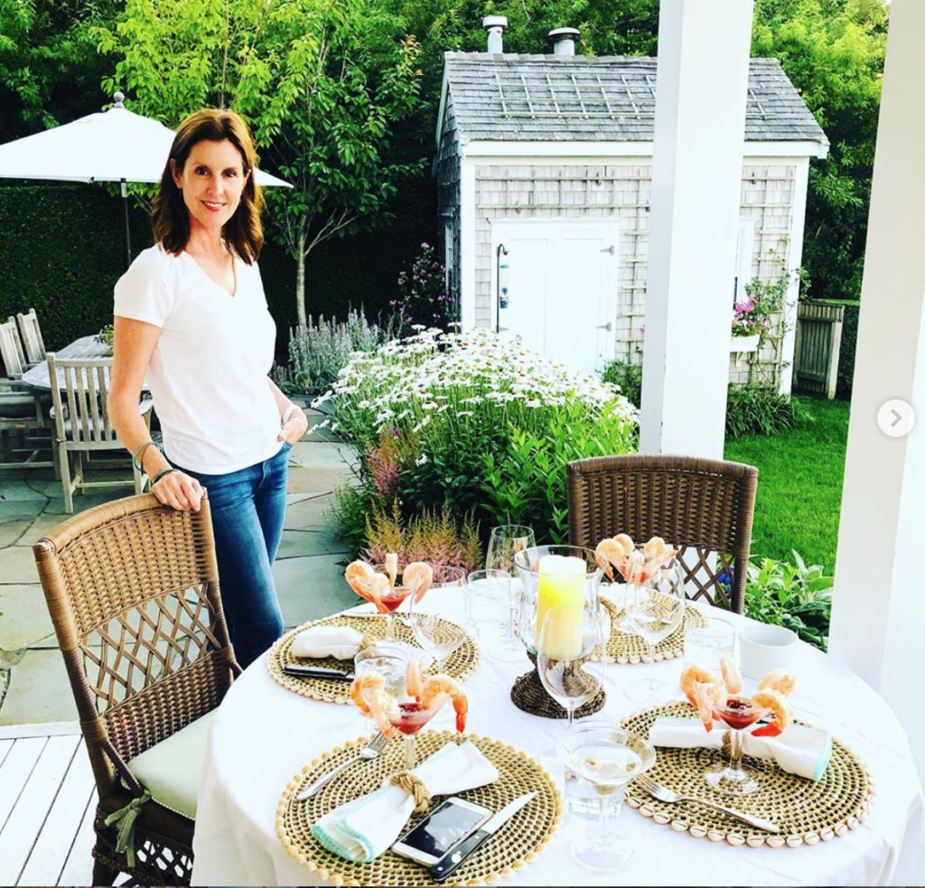 Phoebe Tudor setting the table for four at her vacation home in Nantucket. (Instagram photo)