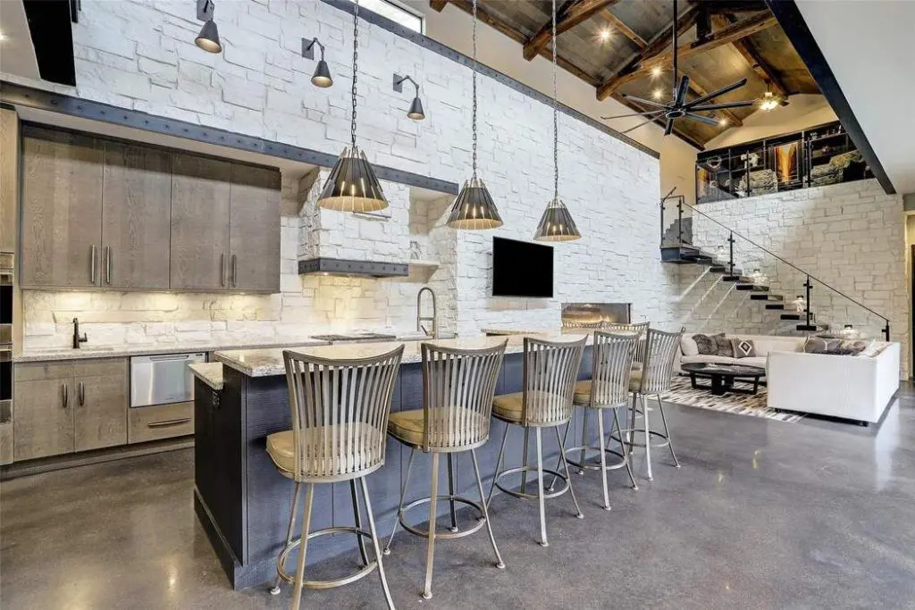 The kitchen has subtle design details such as custom iron banding above the cabinetry and at the vent hood.