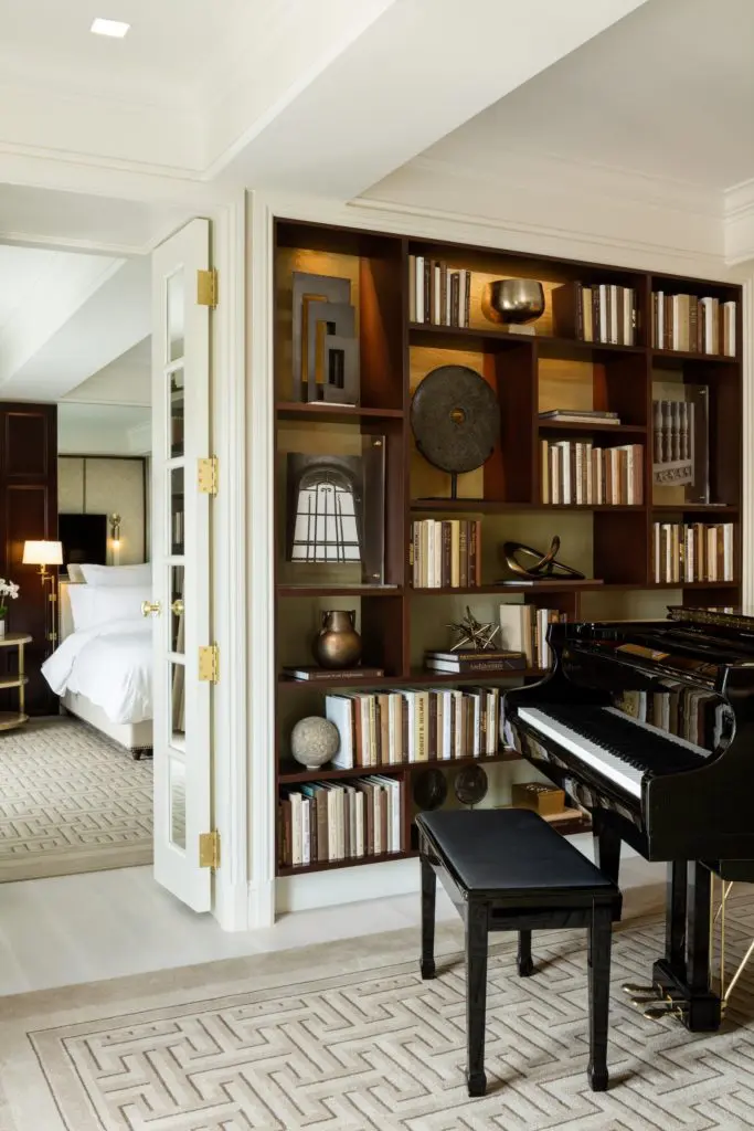 Books, sculptural objects, and a baby grand in the Turtle Creek Suite.