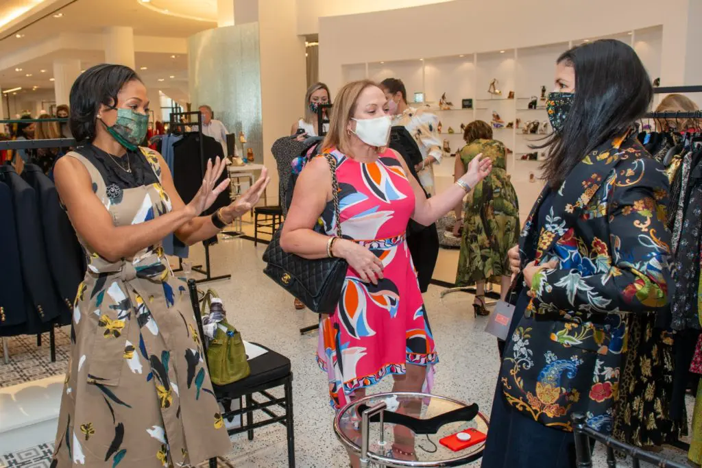 Roslyn Bazzelle, Mignon Gill, Kristy Bradshaw swoon over the Etro brocade jacket. (Photo by Jacob Power)