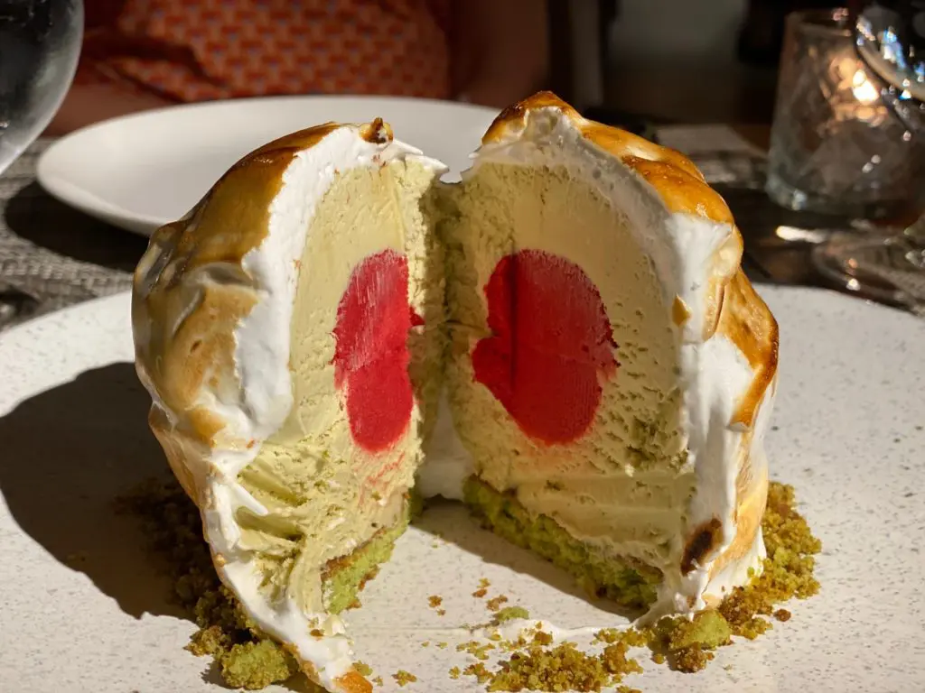 The Baked Alaska is filled with a layer of pistachio ice cream and centered with berry ice cream. (Photo by Shelby Hodge)