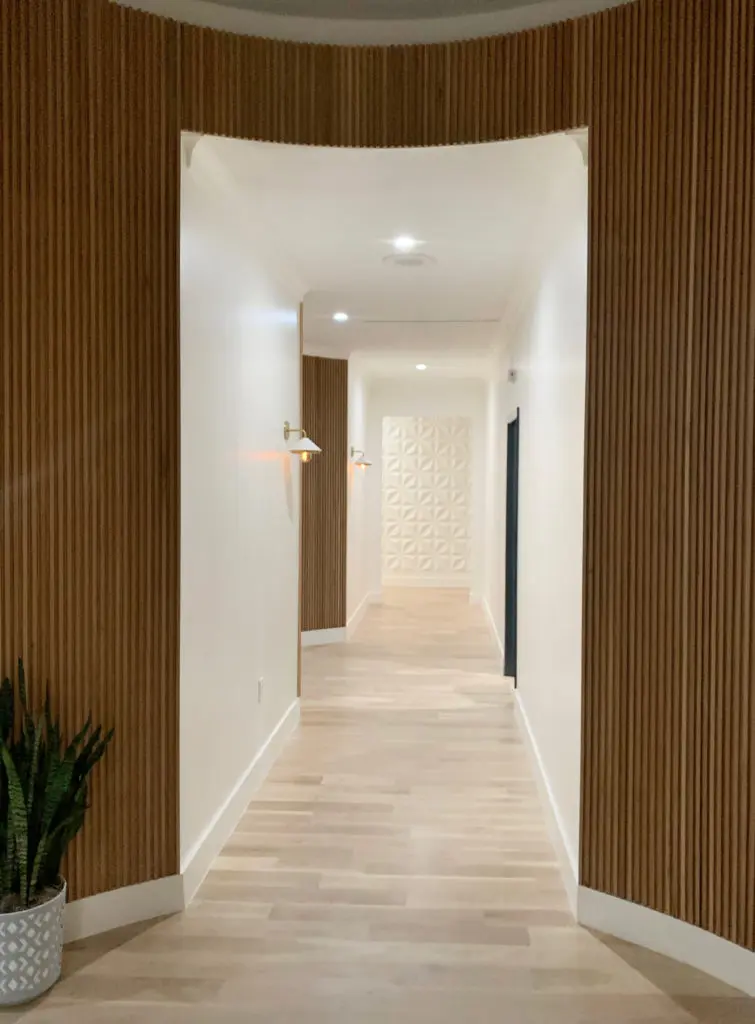 Bright white hallways are lined with mod light fixtures and natural texture. 