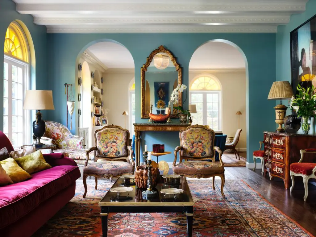 Dallas home: In the living room are a pair of 18th-century French fauteuils and a Maison Jansen coffee table. Custom sofa designed by Alvise Orsini and upholstered in silk velvet. Italian 18th-century gilt carved mirror. (Photo by Lisa Petrole, Styled by Michelle Aviña)