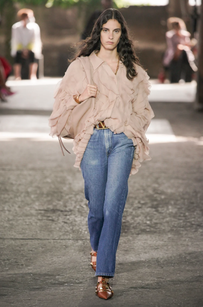 Valentino collaborated with Levi's to showcase the 517 boot cut jean, shown here with chiffon blouse. (Photo courtesy of Valentino)