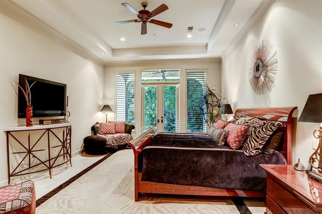 The home's master opens to pool and ravine beyond.