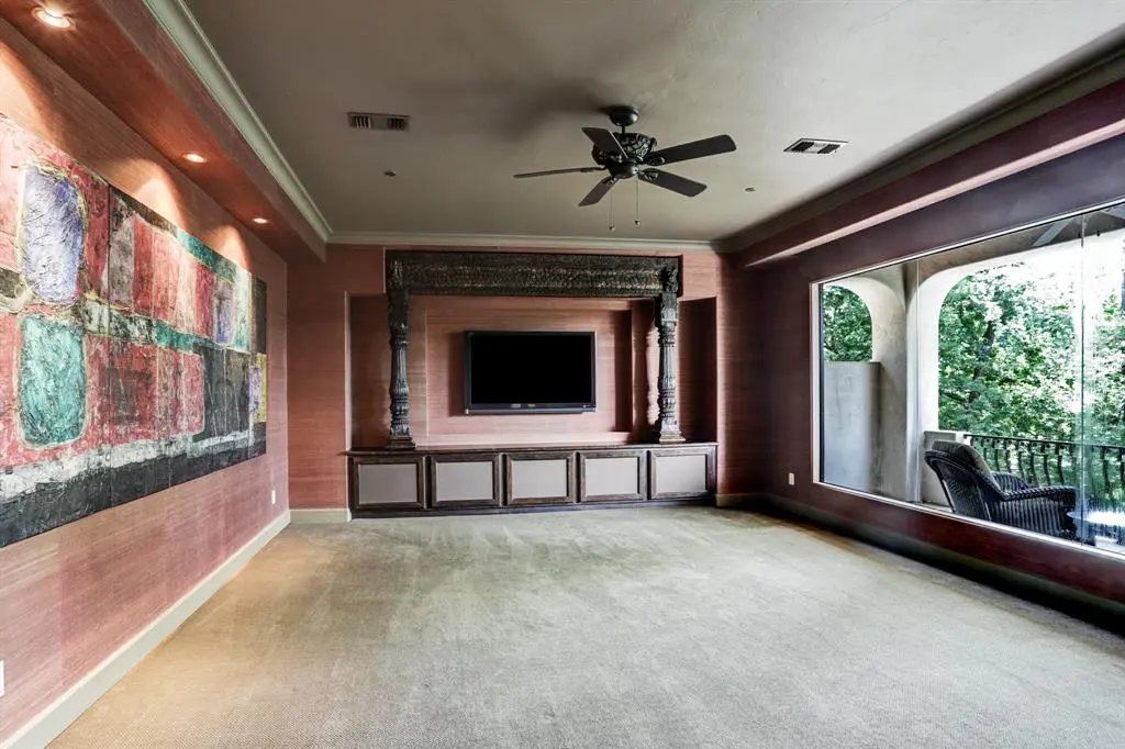 Second floor media room overlooks the pool.
