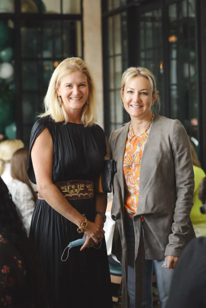 Allison Crosswell and Callie Simmons, masks in hand, unmask for a photo at The Annie Cafe & Bar Sunday brunch. (Photo by Johnny Than)