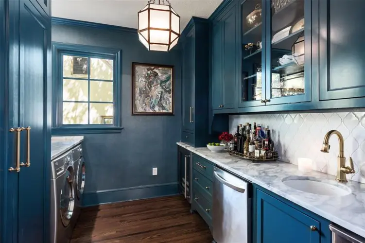 The laundry room and wet bar earns a moody paint job. 