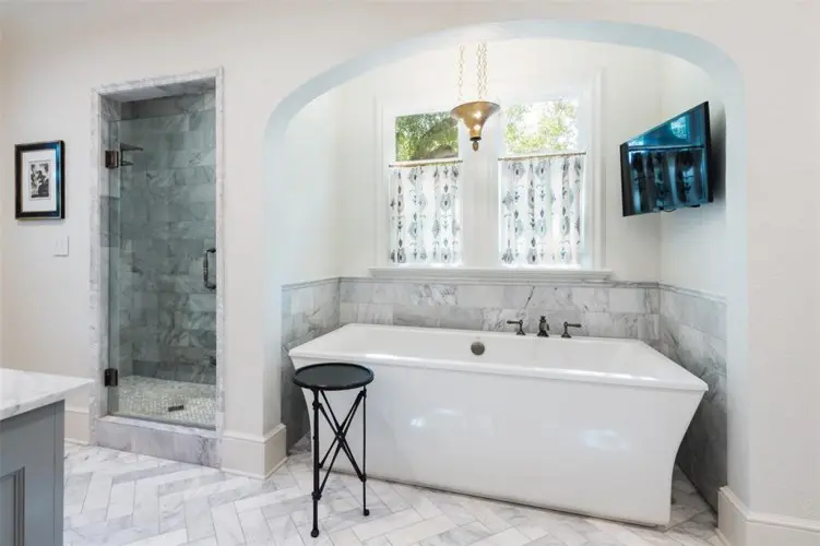 The master suite includes heated floors and a garden tub. 