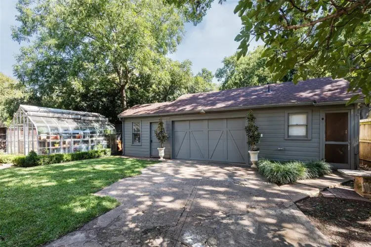 A two-car garage and green house. 
