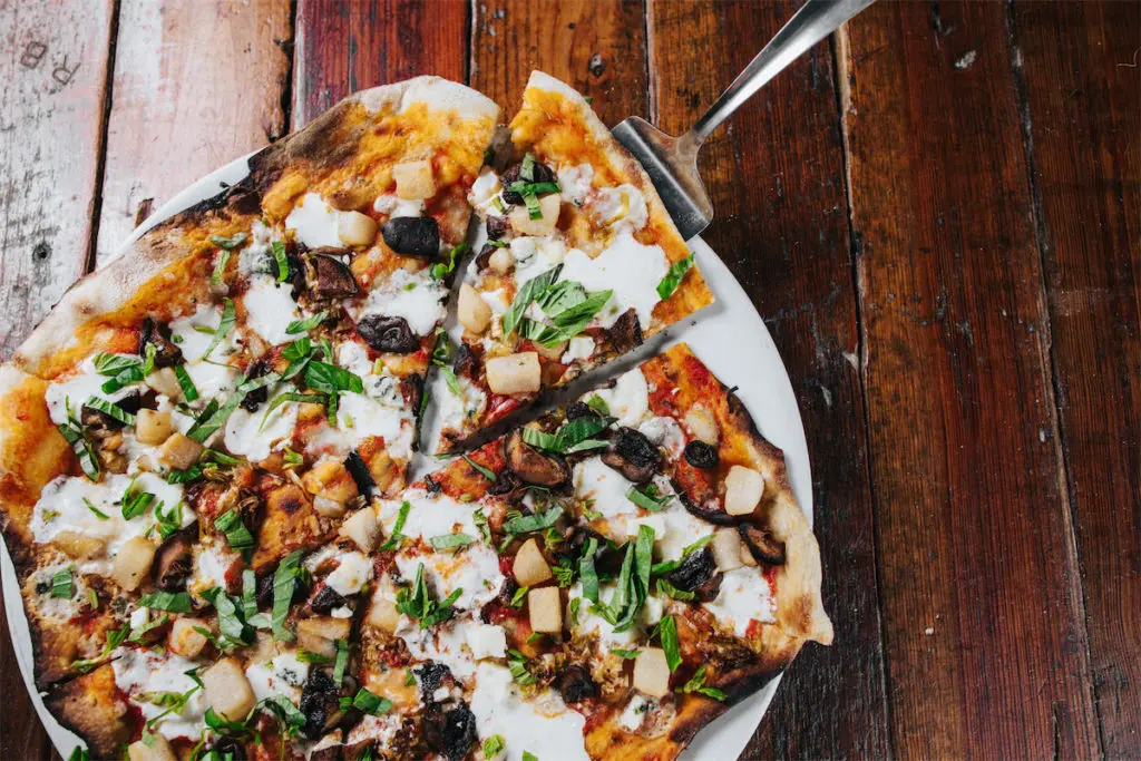Flatbreads include the Pear and Gorgonzola with leeks, mushrooms, and more. (Photo by Kathy Tran)