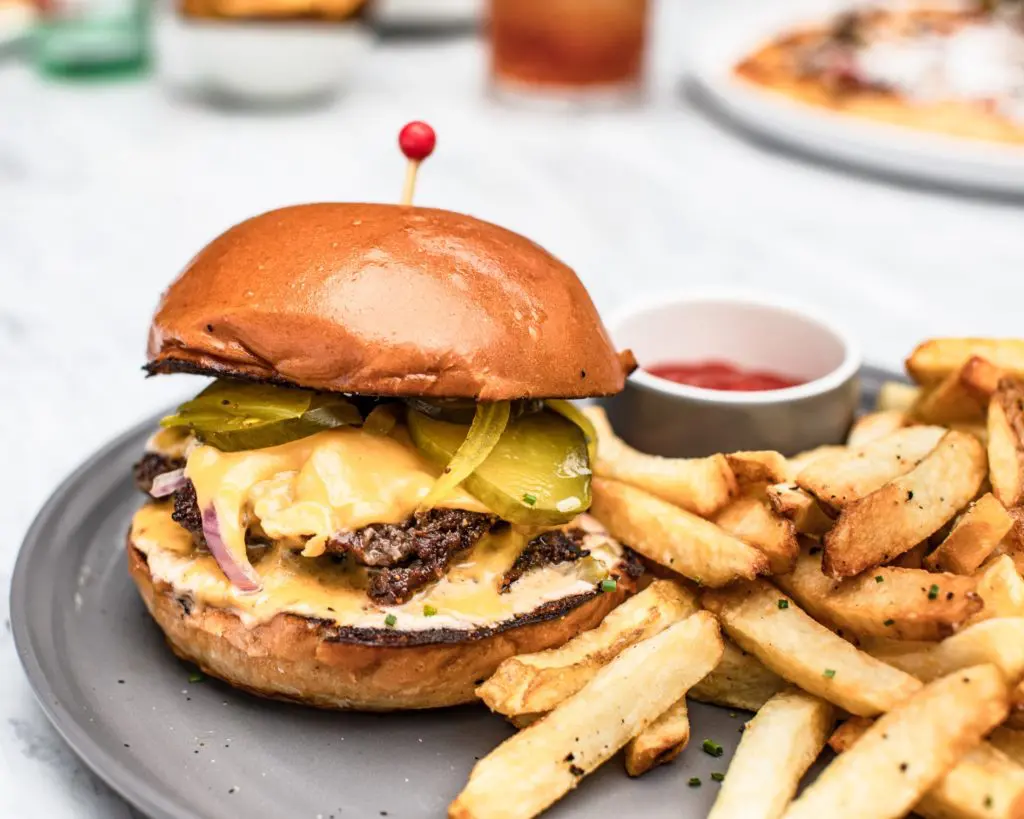 The Sporting Club Burger and hand-cut fries cooked in beef fat is a menu favorite of The Sporting Club director of operations for Houston Brandon Duliakas. (Photo by Corine Michel )