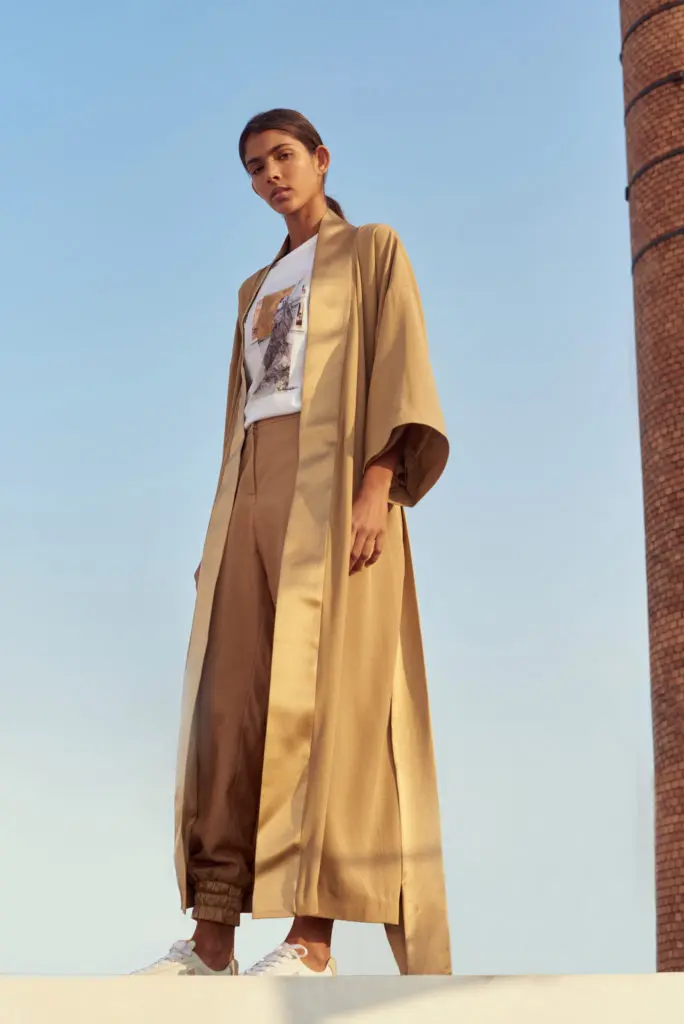 Designed to acknowledge the change in our daily lifestyle, the capsule includes effortless styles, like this kimono-style camel coat, fully lined in silk. 