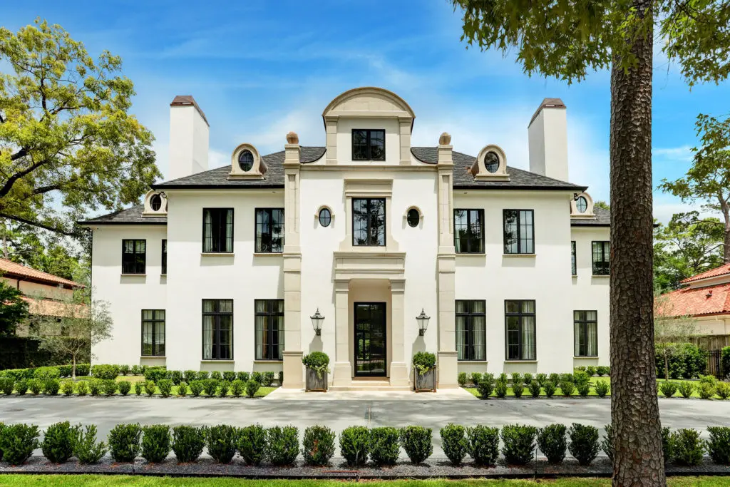 The grand French Contemporary dwelling at 722 East Friar Tuck Lane in close-in Memorial designed by Charles Ligon, AIA, is listed with Compass.