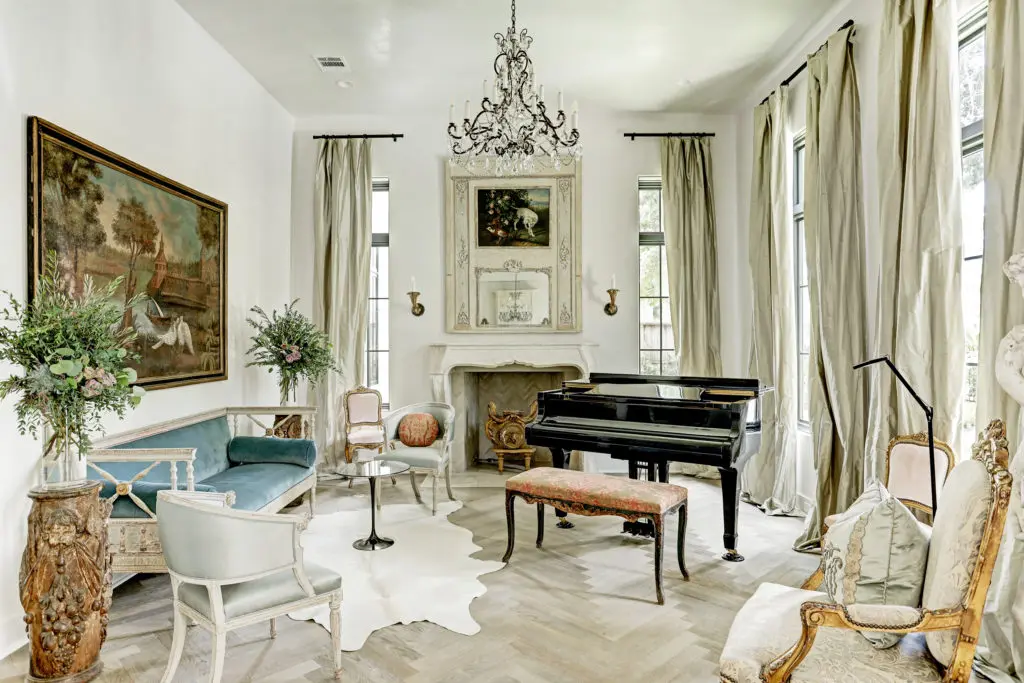 The formal living room at 722 E. Friar Tuck Lane is centered around the gas fireplace with a late 18th century mantle from Bordeaux.