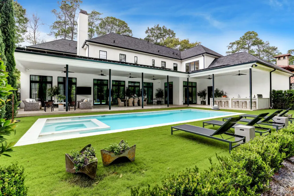 Multiple covered seating areas with ceiling fans, fully equipped summer kitchen and tanning deck at 722 E Friar Truck Lane.