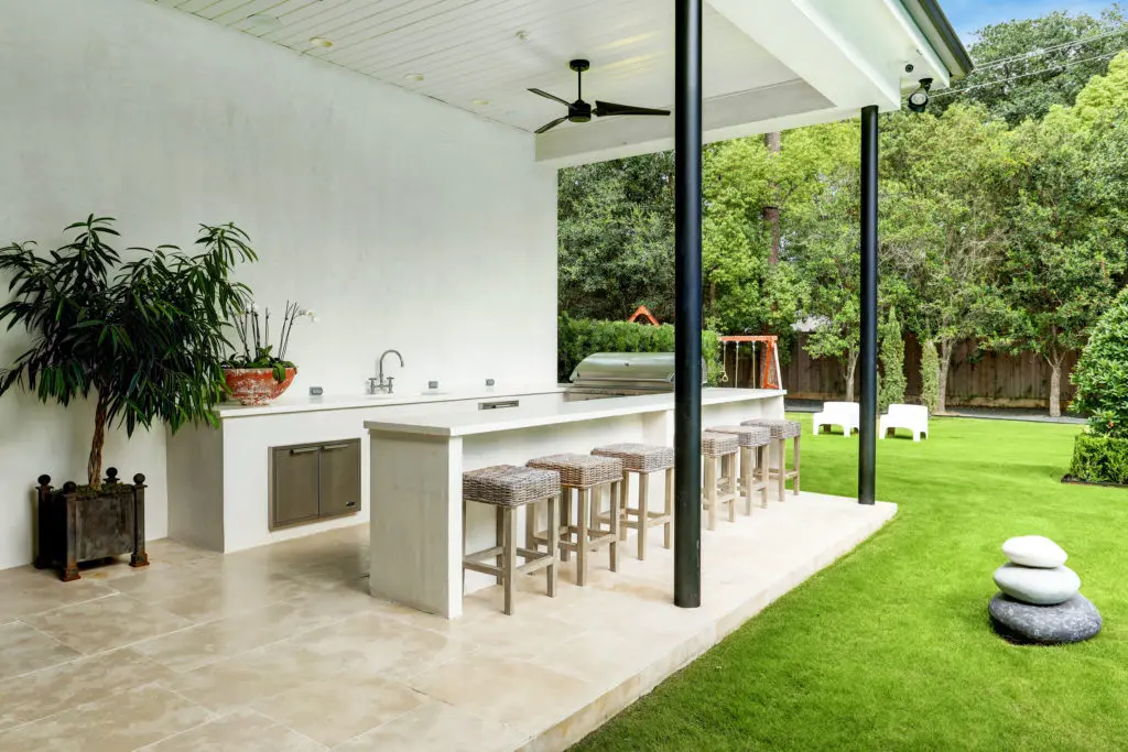 The spacious outdoor summer kitchen/living area at 722 E. Friar Tuck Lane has a home theater.
