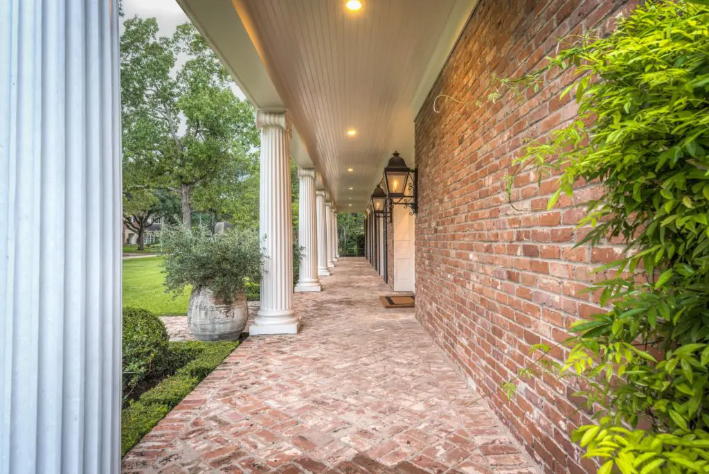 Brick pavers line the dramatic front porch.