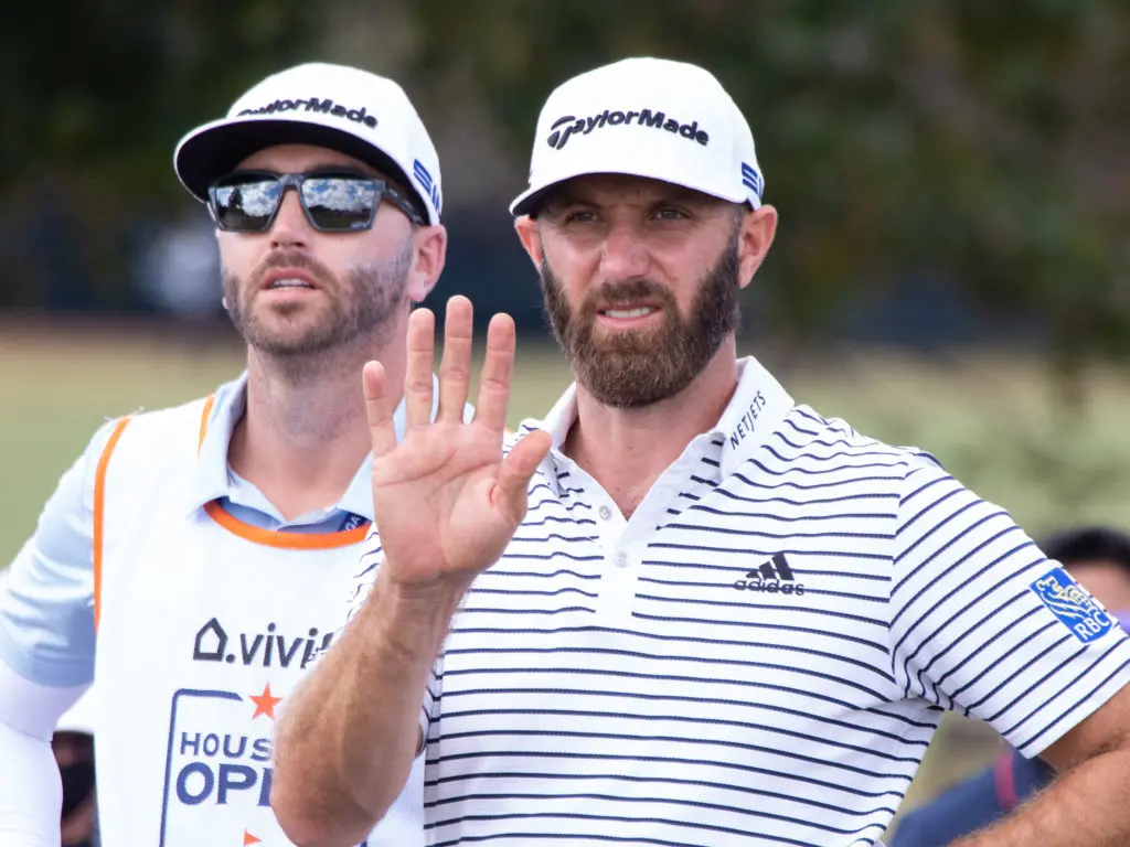 Number one ranked golfer Dustin Johnson feels the wind before teeing off. (Photo by F. Carter Smith) 