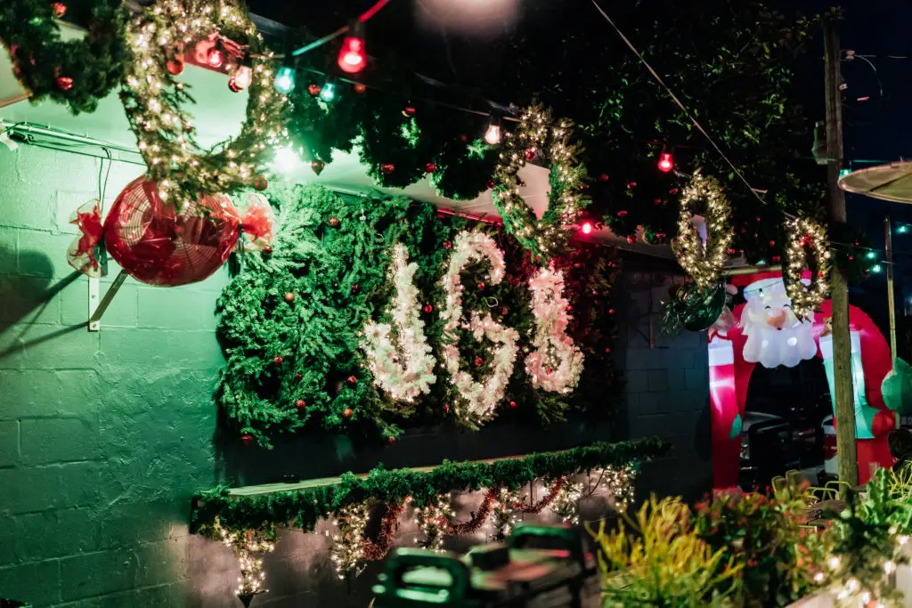 Front of Johnny's Gold Brick decorated in wreathes and lights for Miracle At Johnny's.