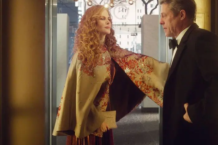 A stunning, embroidered cape covers Nicole Kidman's gown as she speaks to Hugh Grant at a black-tie affair in this scene from HBO's 'The Undoing.' (Image courtesy of HBO.) 