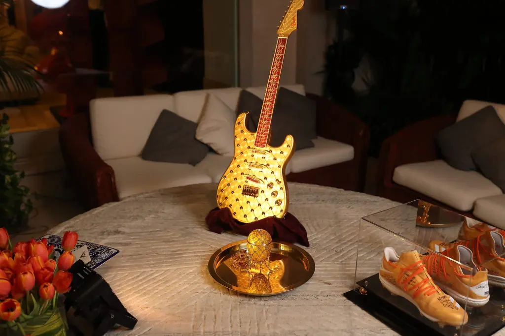 Gilded guitar and Fabergé egg for auction at the Correa Family Foundation dinner hosted by Fabergé at the home of Isabel and Ignacio Torras. (Photo by Quy Tran)