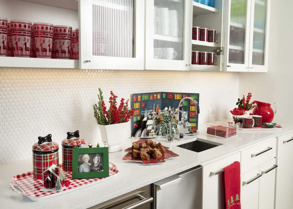 The serving buffet filled with Christmas serveware.