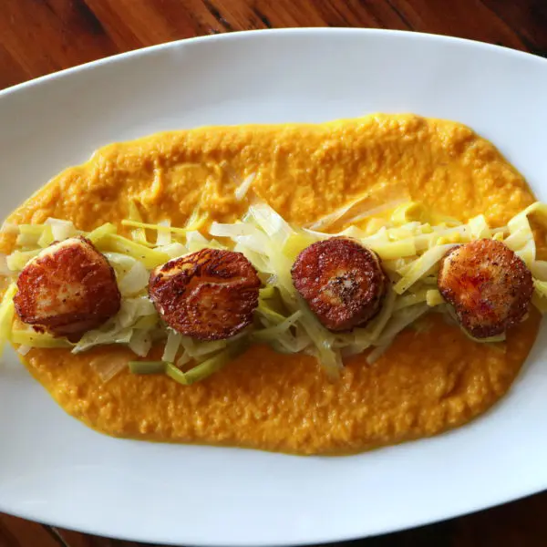 Seared Scallops on Leek Nest with Carrot Sauce