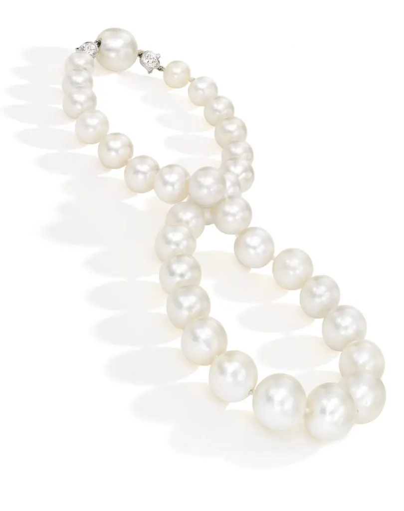 <b>A Rare Natural Pearl and Diamond Necklace</b>
Composed of 32 natural pearls measuring approximately 14.9 x 14.8 to 9.2 x 9.0 mm, the clasp accented with two round diamonds in floral mountings, length 16¾ inches.
Estimate $300/500,000
