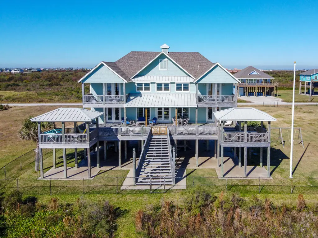 The three-story vacation home boasts an elevator, sprinkler system and electronic door shutters.