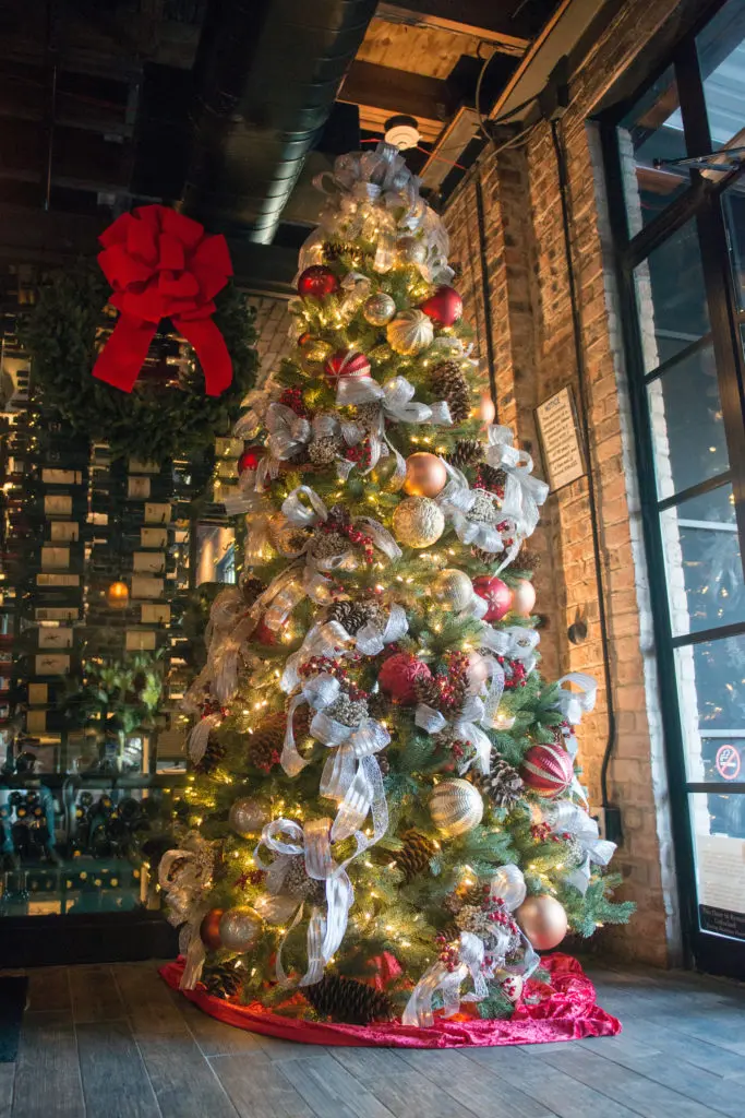 Guests return to B&B Butchers each holiday season to be photographed with the gilded Christmas tree. (Photo by Jacob Power)
