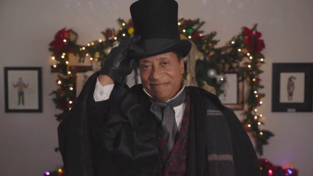 David Rainey takes the role of Scrooge and stage manager in the play within a play. (Photo by John Carrithers)