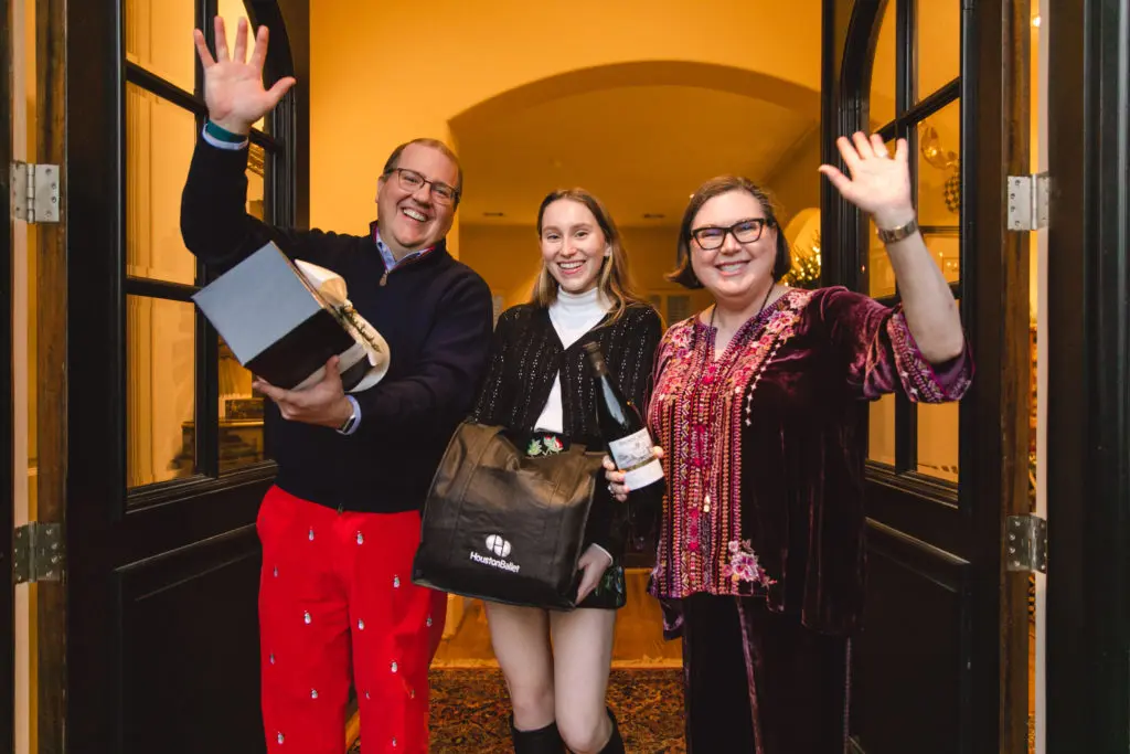 Jim Jordan and Shawn Stephens with their daughter, Shelby Jordan, welcome the Houston Ballet Jubilee of Dance dinner packet from Jackson & Company.(CatchLightGroup photo)