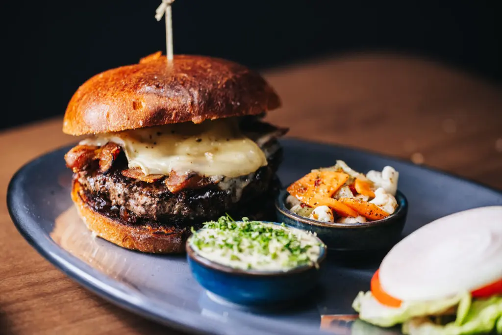 Go-to dishes at Ounce include The Ounce Burger with a Beeman Ranch wagyu patty, bacon, and sherry-onion jam. (Photo by Kathy Tran)