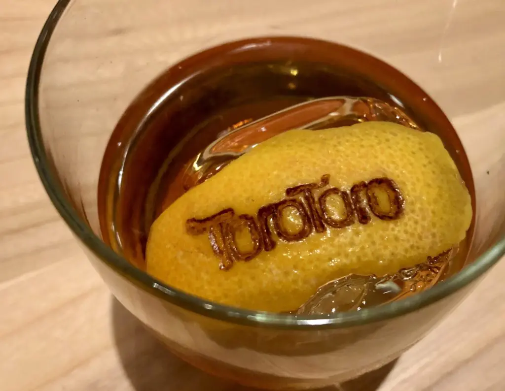 Toro Toro's Manhattan with branded orange peel. Photo by Courtney Dabney.