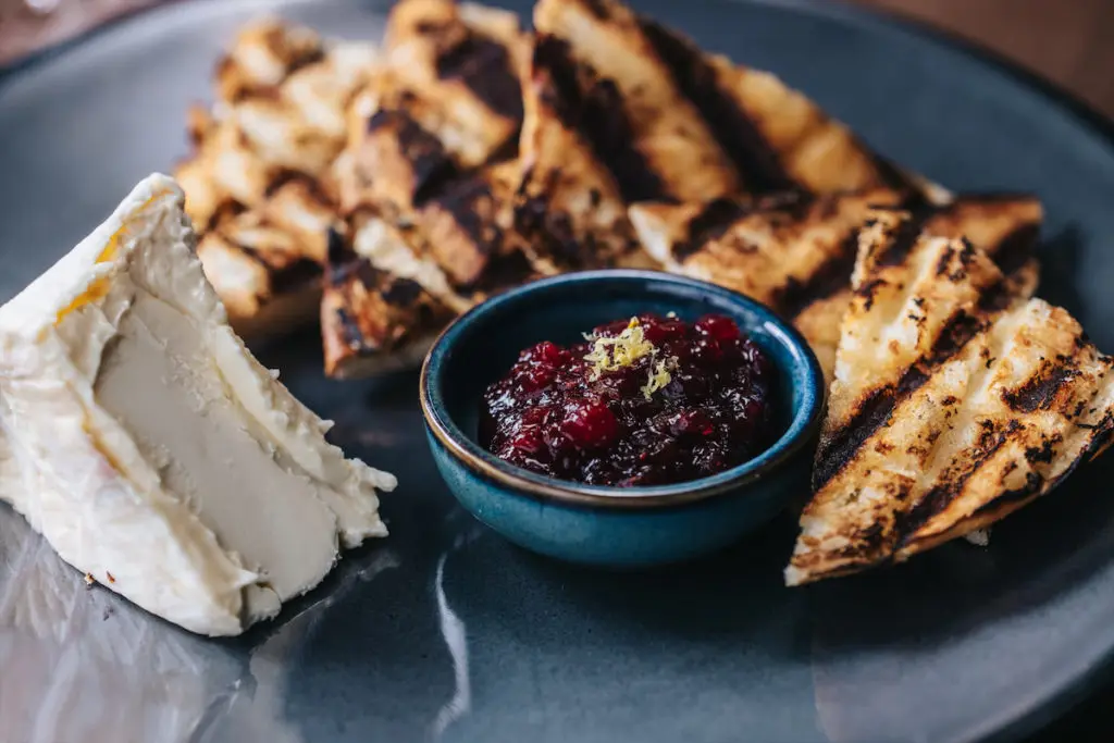 A triple cream cheese with jam and toast also serves as a snack at Ounce. (Photo by Kathy Tran)