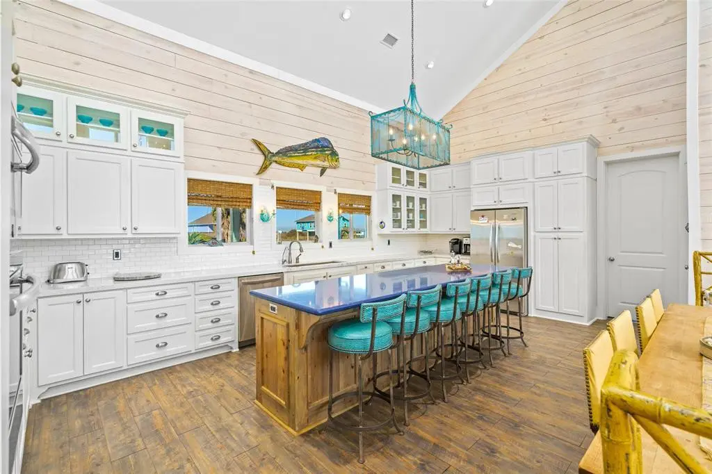 The cobalt blue Silestone island is focus of kitchen activity in this vacation home.